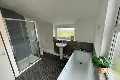 Modern bathroom featuring a spacious bathtub, a...