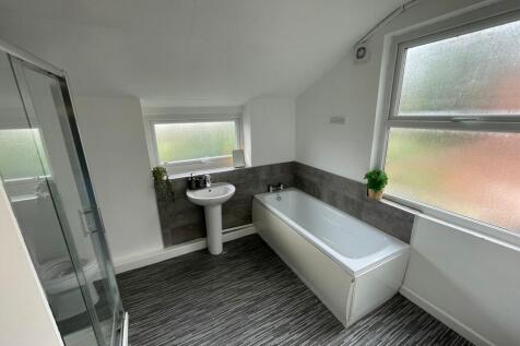 Bright and modern bathroom featuring a large ba...