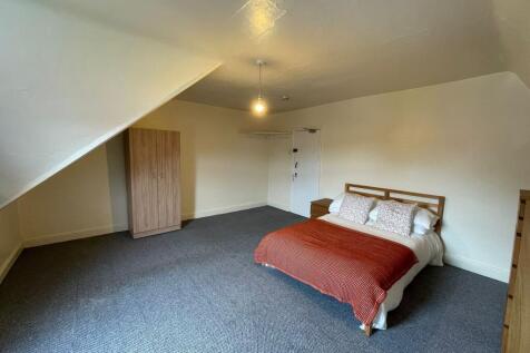 Spacious double bedroom featuring a comfortable...