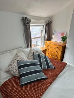A bright and inviting double bedroom featuring ...