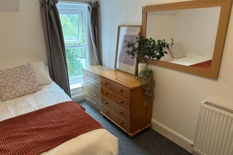 Cozy double bedroom featuring a comfortable bed...