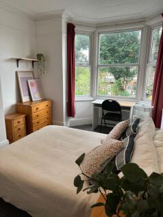Bright and welcoming master bedroom with a larg...