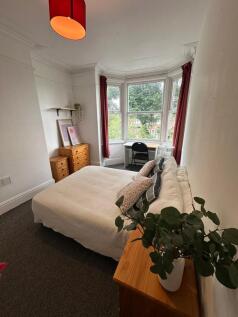 Bright and spacious master bedroom with large b...