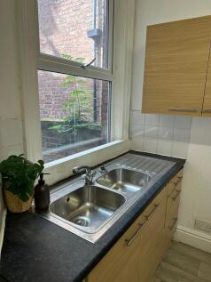 A bright, clean kitchen with dual stainless ste...