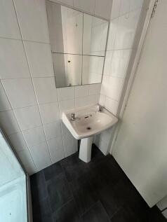 Clean and functional bathroom with a white sink...