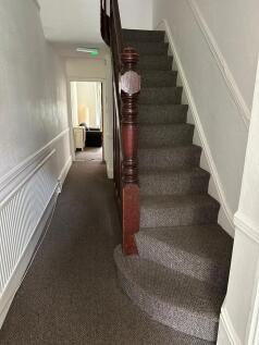 A well-maintained staircase with dark wooden ba...