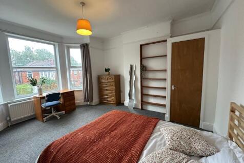 Bright and airy bedroom featuring large windows...