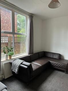 A bright and welcoming living room featuring a ...