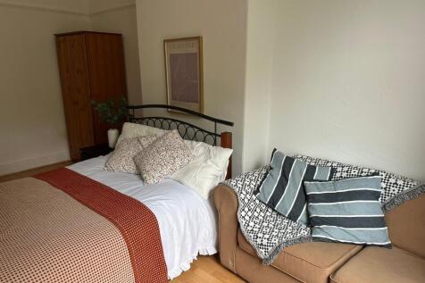 A spacious, well-maintained master bedroom feat...