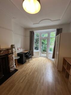 Bright and inviting living room with large bay ...