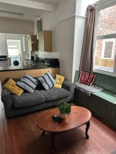 Bright and cozy living room featuring a comfort...