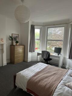 Bright and inviting living room with large bay ...