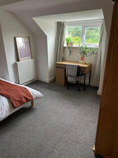 A cozy, well-maintained single bedroom with a c...