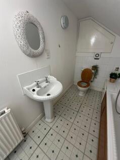 Bright and clean bathroom with a traditional si...