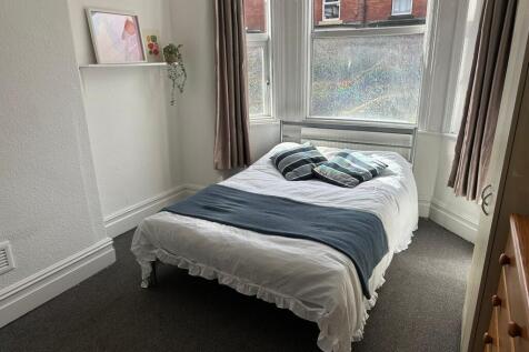 Bright and cozy bedroom with ample natural ligh...