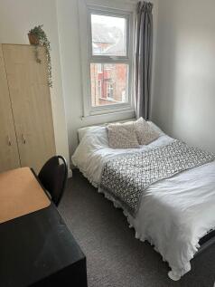 Bright and inviting double bedroom with a large...