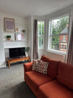 Bright and inviting living room with large wind...