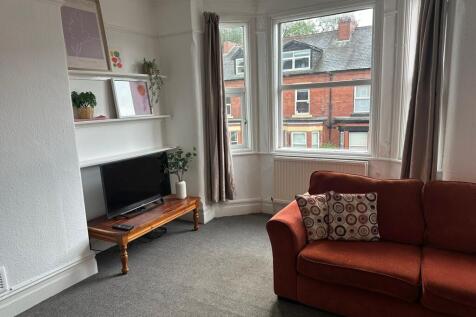 Bright and welcoming living room with large bay...