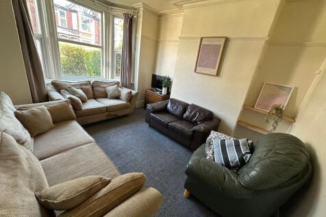 Spacious and bright living room featuring a lar...