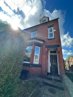 A charming red-brick house with a classic front...