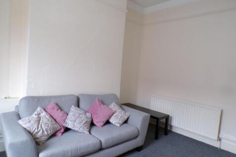 A spacious living room featuring a comfortable ...