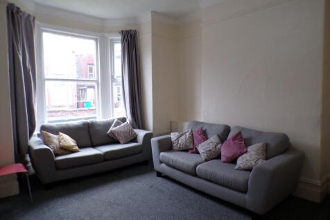 A spacious living room featuring two comfortabl...