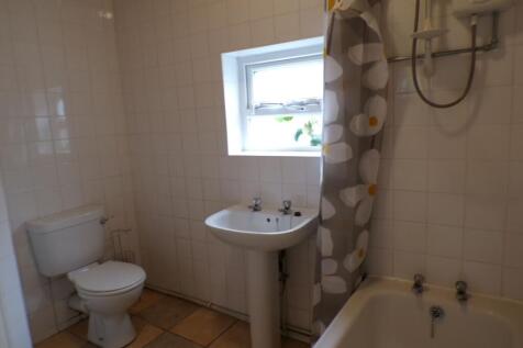 Bright and clean bathroom with a small window a...