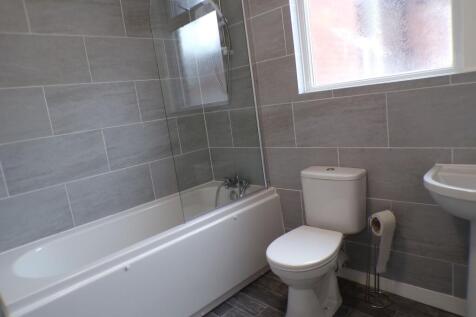 Modern and clean bathroom featuring a bathtub w...