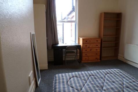 A cozy bedroom featuring a window allowing for ...