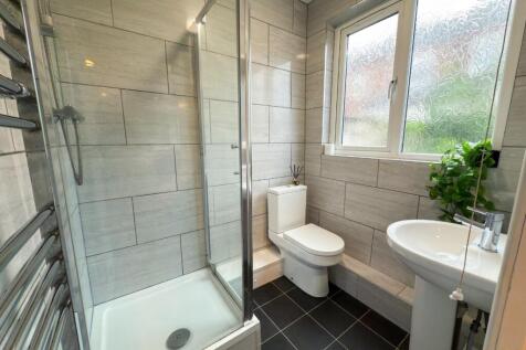 A modern, well-maintained bathroom with a showe...