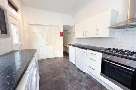 Bright and modern kitchen with ample white cabi...