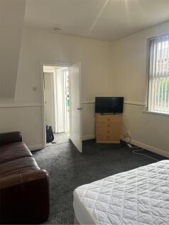 A spacious and inviting double bedroom with amp...