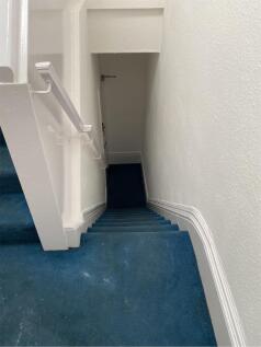 A well-maintained staircase leading to upper le...