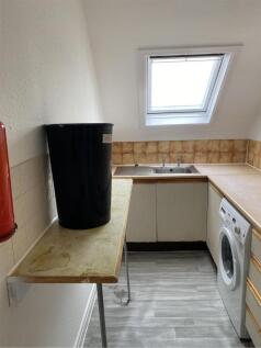 A cozy kitchenette with a bright window, offeri...