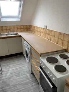 A tidy and functional kitchenette featuring ess...