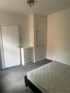 A spacious double bedroom with ample storage an...