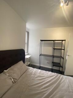 A cozy double bedroom featuring ample natural l...
