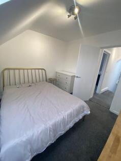 A bright and inviting double bedroom with moder...