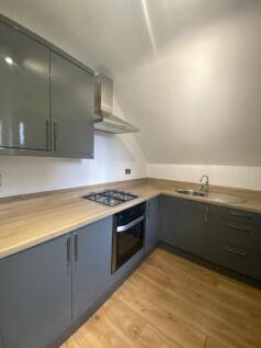 A modern and tidy kitchenette featuring sleek c...