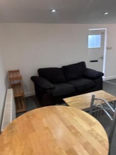 A cozy living room area with a comfortable sofa...