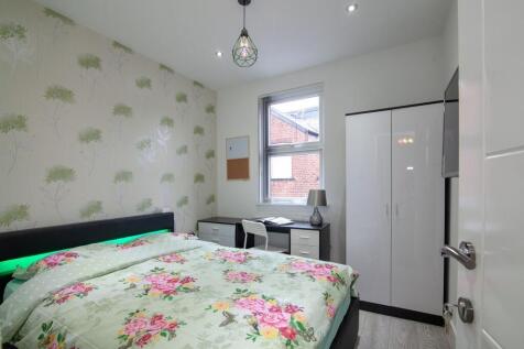 A bright and inviting double bedroom featuring ...