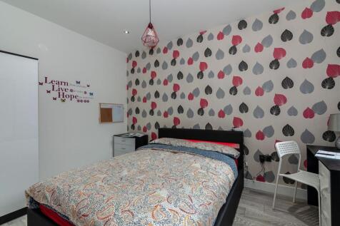 A stylish and cozy double bedroom with vibrant ...