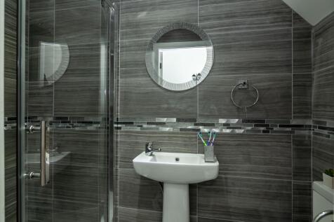 A modern and stylish bathroom featuring a sleek...
