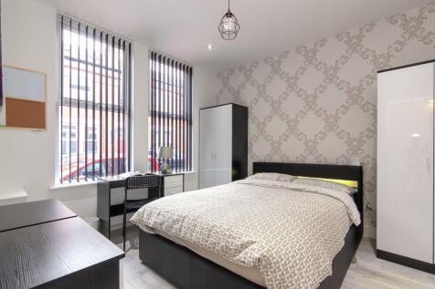A bright and spacious double bedroom featuring ...