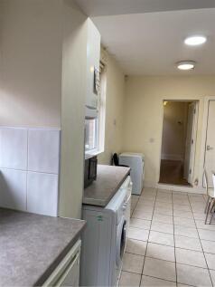 A spacious kitchen with ample natural light, fe...