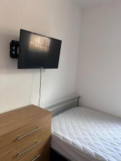 A tidy and well-lit double bedroom featuring a ...