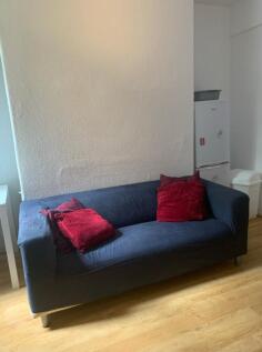 A cozy living room with a comfortable sofa, ide...