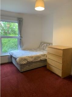 A bright and cozy double bedroom featuring a co...