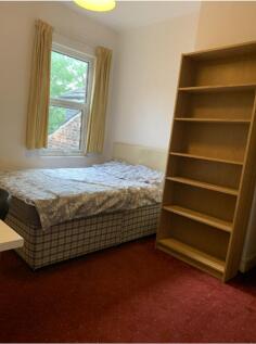 A cozy double bedroom with ample natural light ...