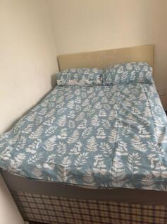 A cozy double bedroom with a comfortable bed, p...